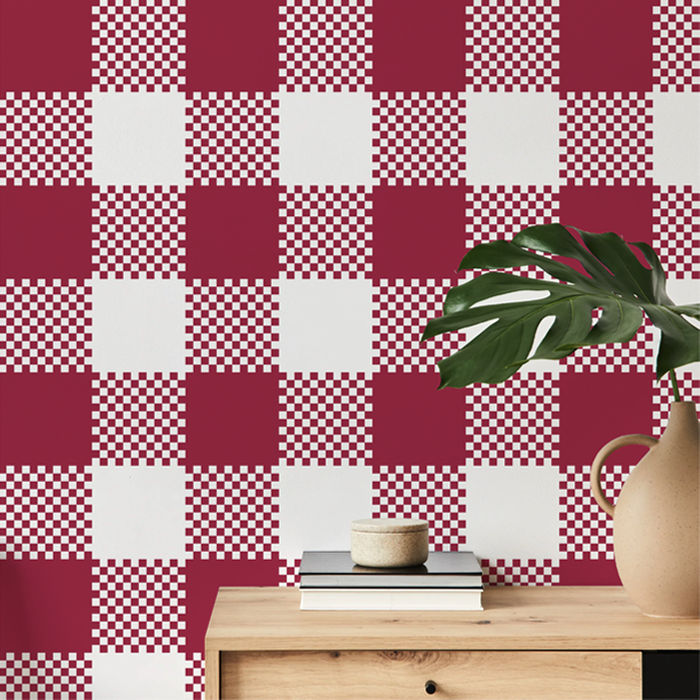 raspberry pink plaid wallpaper on a hallway wall with an oak console table and monstera