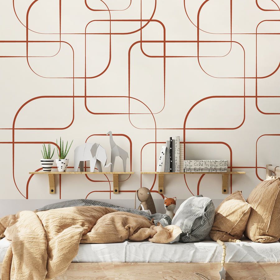 A children's bedroom which features the Wistera wallpaper which is geometric thin red lines forming overlapping squares and rectangles on a soft beige background.